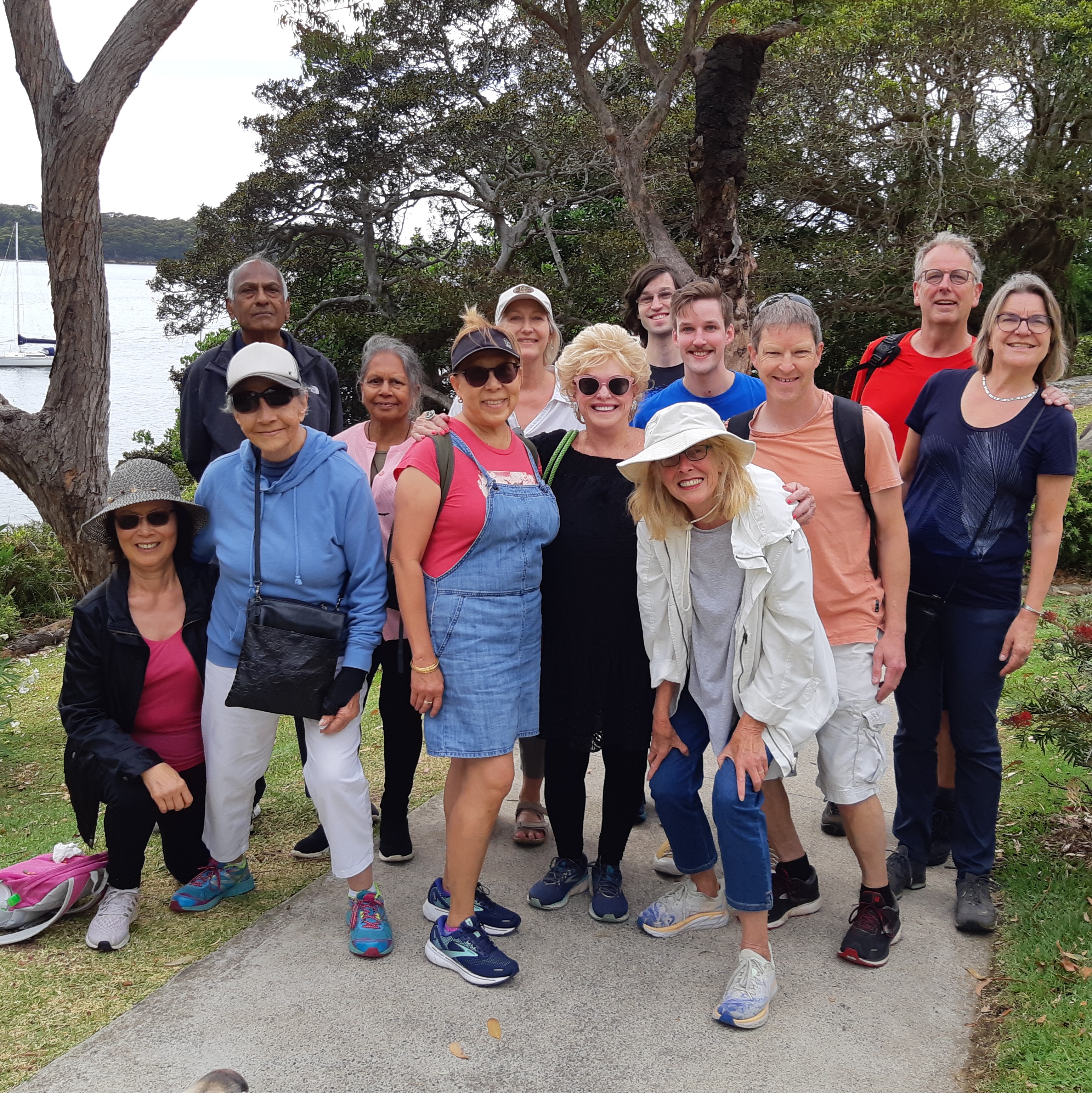 A group of people standing on a walking path